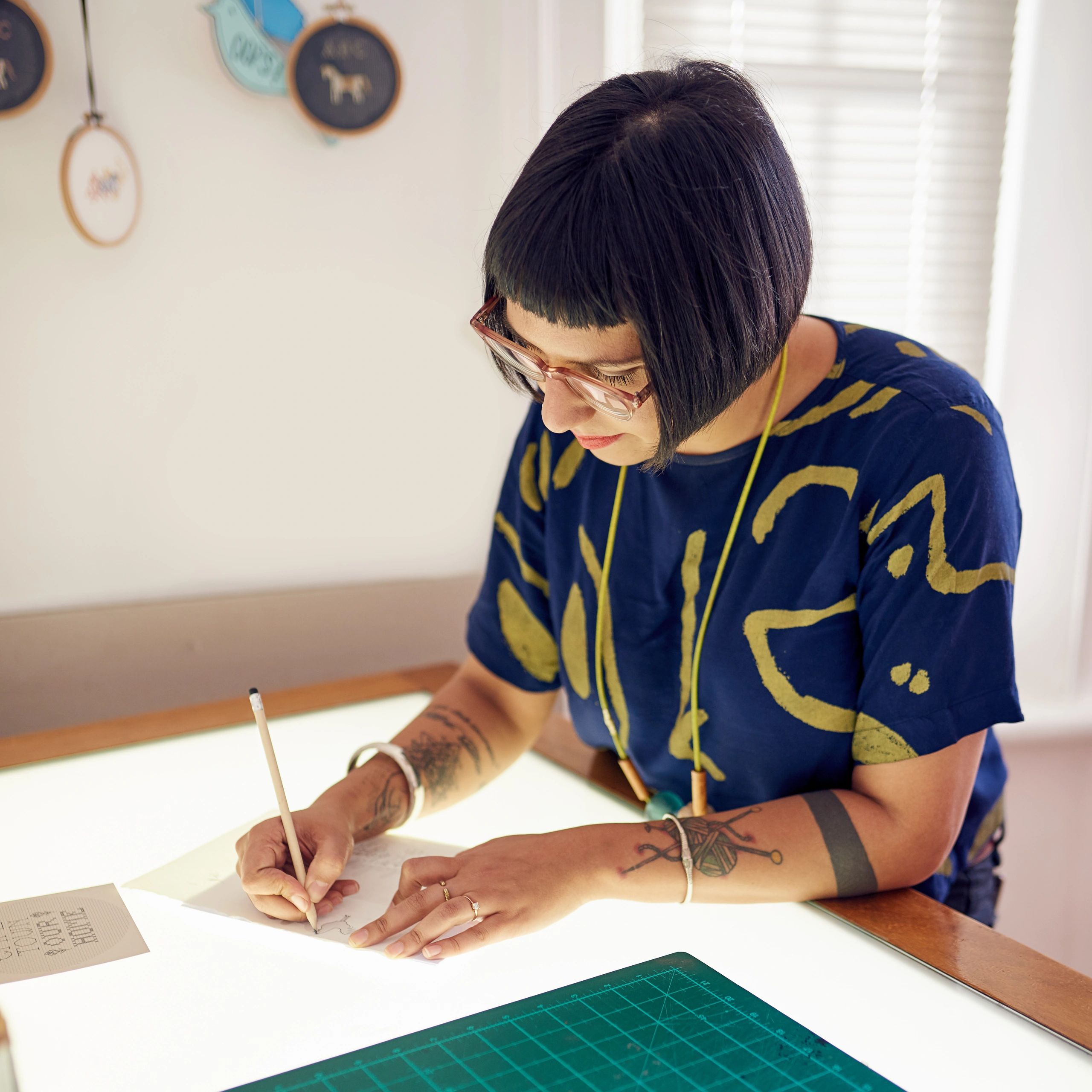 Designer working at a light table in a studio